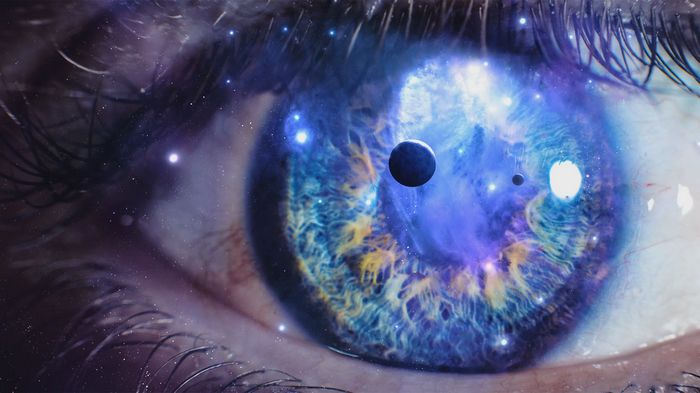 Eye reflecting a galaxy with planets