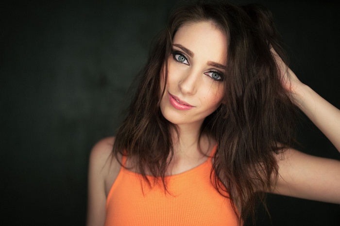 Woman with hands in hair, portrait