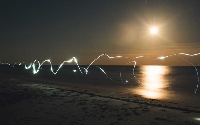 Long exposure light painting on a beach at night