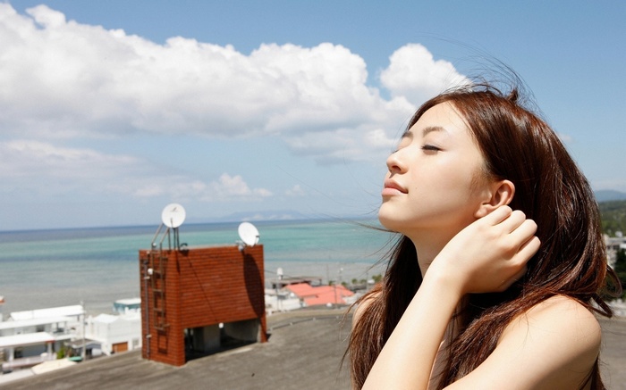 Rina Aizawa with hands in hair outdoors