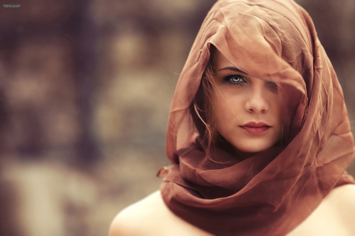 Woman with blue eyes wearing a brown scarf