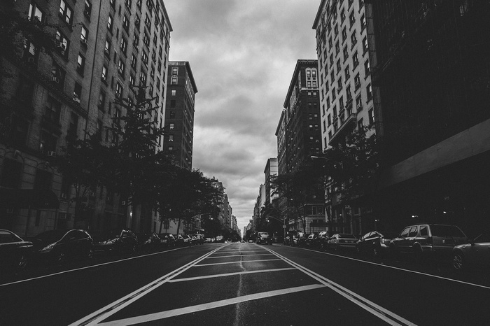 City street with tall buildings and parked cars