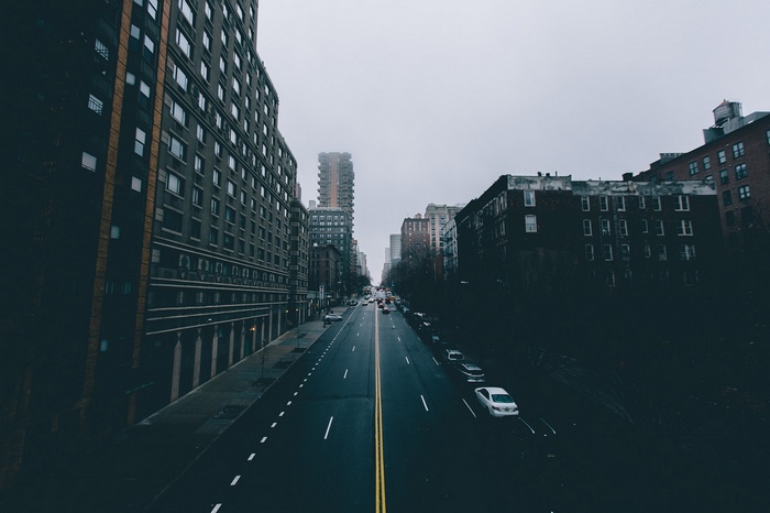 City street in mist with buildings and cars