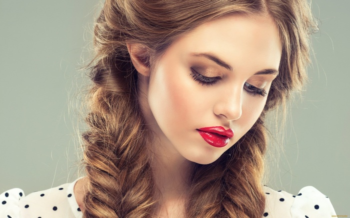 Woman with auburn hair and red lipstick