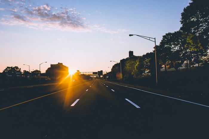 Highway at sunset with sun flare