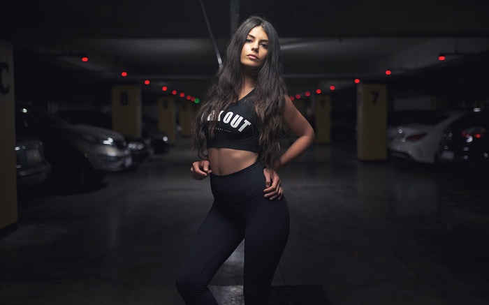 Woman in Nike workout clothes in a parking lot