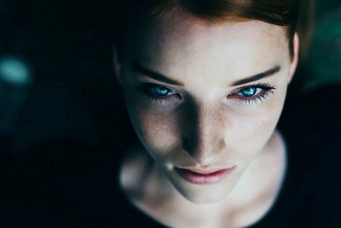 Portrait of a woman with blue eyes and freckles