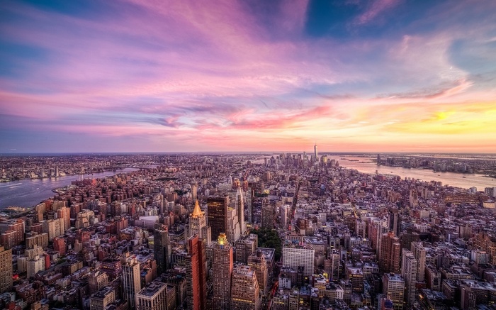 New York City skyline at sunset with colorful clouds