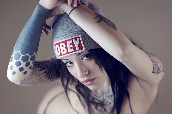Woman with tattoos wearing an OBEY beanie