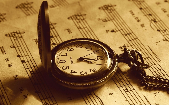 Vintage pocket watch on sheet music