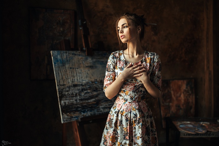 Woman in a floral dress in an artist's studio