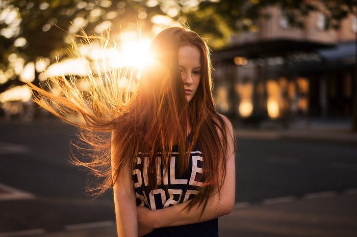 Redhead woman with freckles in sunlight