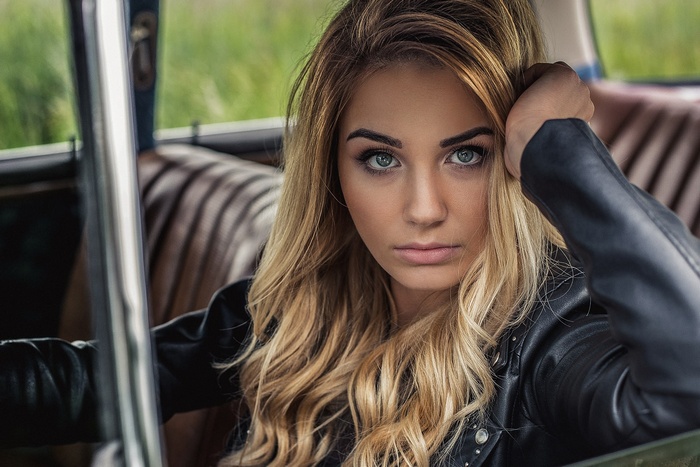 Portrait of a blonde woman in a car