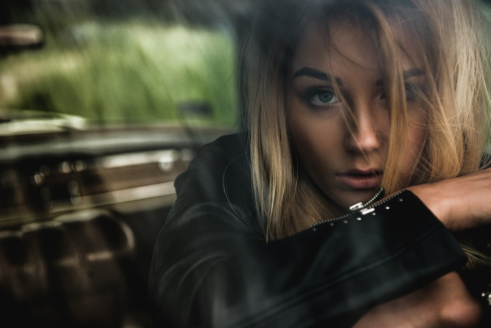 Woman with blonde hair in a black jacket