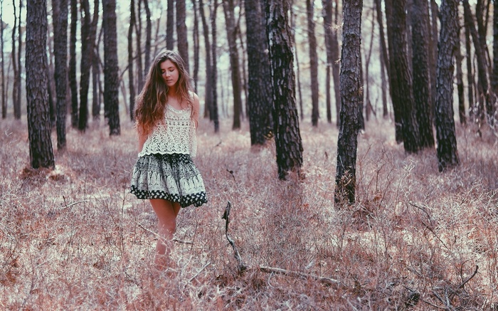 Woman in a forest with dry grass