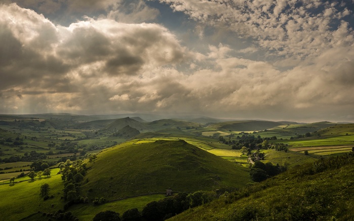 Rolling green hills under dramatic clouds in the UK