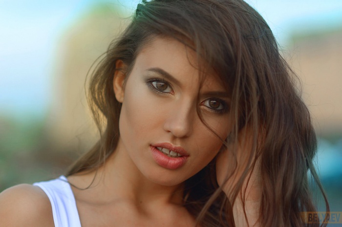 Woman with long brown hair and brown eyes