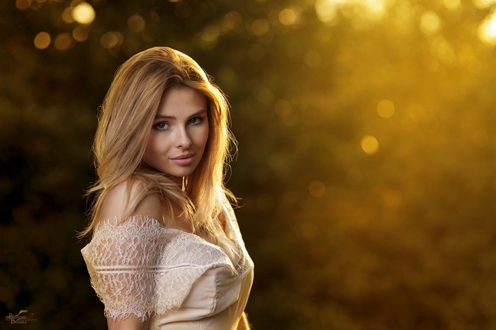 Portrait of a blonde woman in a lace dress