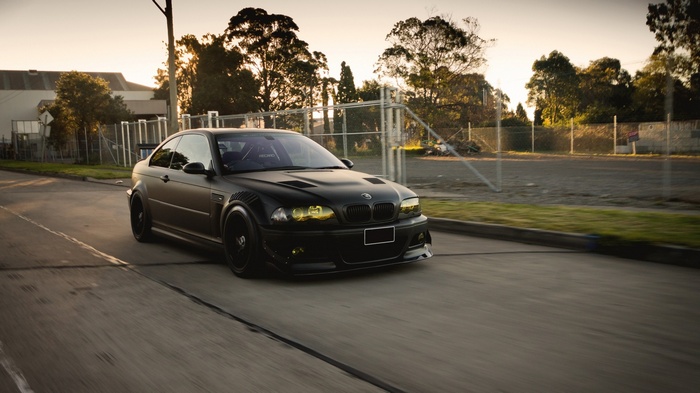 Matte black BMW M3 E46 driving on a road
