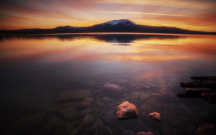 Lake with mountains and colorful sunset reflection