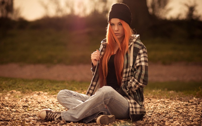 Redhead woman in beanie and plaid jacket outdoors