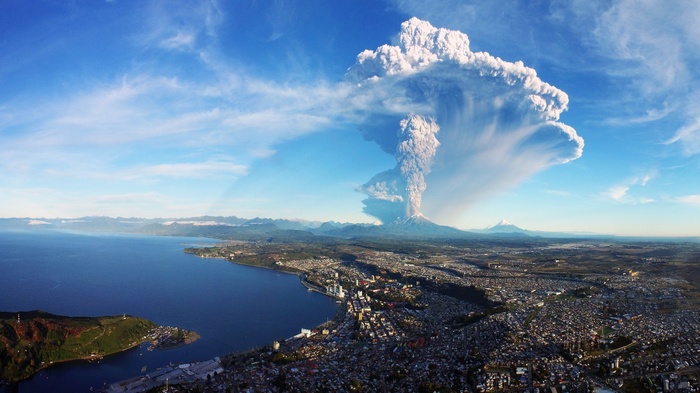 sea city aerial view mountains eruption house water nature building snowy peak coast volcano clouds hills cityscape birds eye view Chile smoke