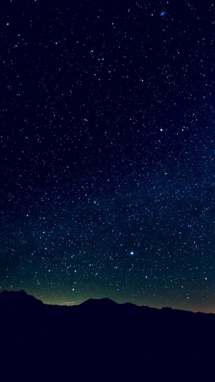 Starry night sky over mountains
