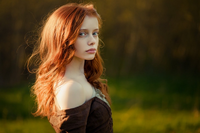 Portrait of a young redhead woman with blue eyes