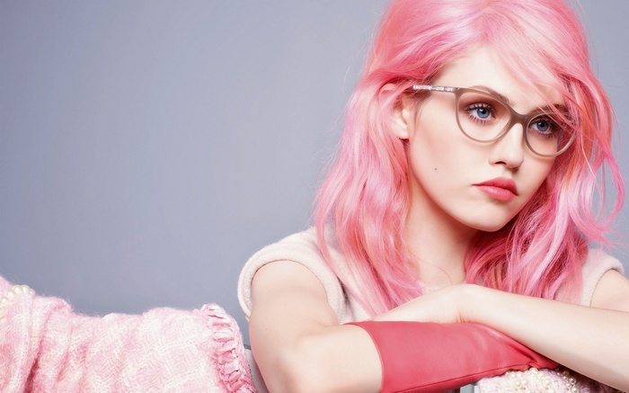 Woman with pink hair and glasses