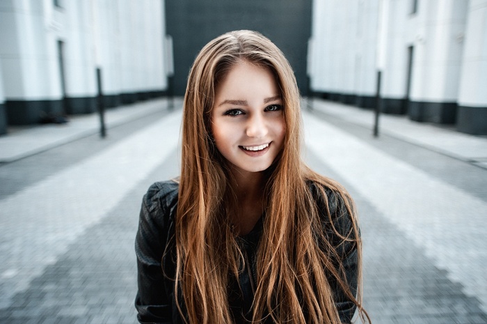 Anastasia in a leather jacket smiling
