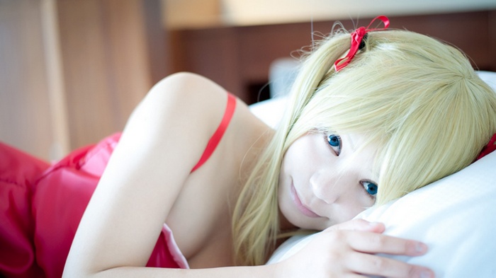 Cosplayer with blonde twintails and blue eyes