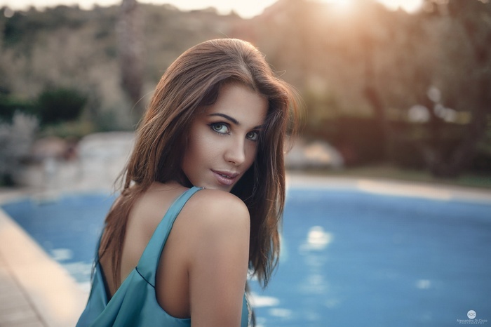 Woman with brown hair by a pool