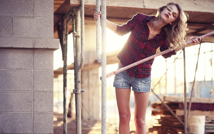 Woman in Plaid Shirt and Jean Shorts on Scaffolding