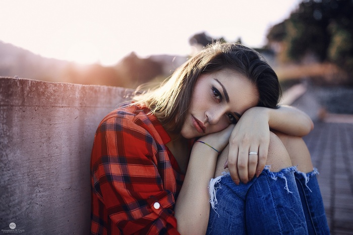 Woman in torn jeans and plaid shirt outdoors