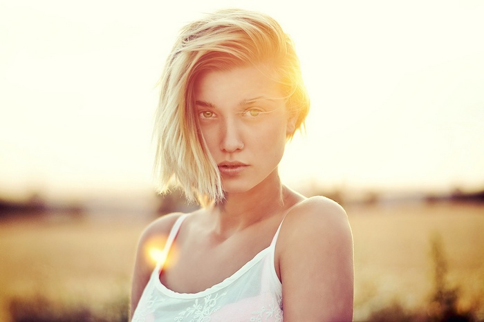 Portrait of a blonde woman with hazel eyes at sunset
