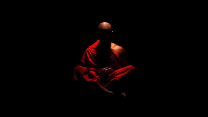 Monk meditating in red robes
