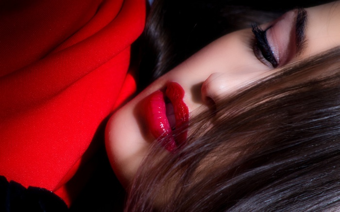Woman with red lipstick and red fabric