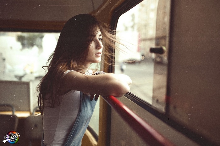 Woman looking out of a bus window