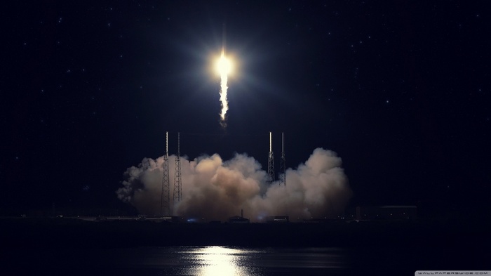 Atlas V rocket launch at night