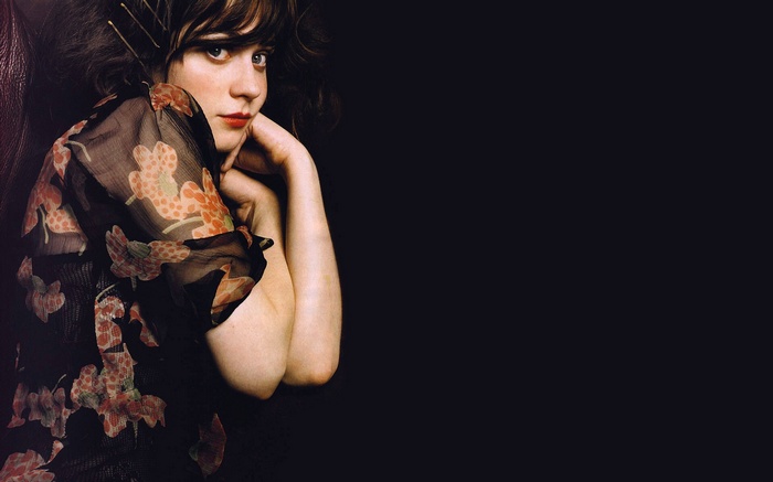 Zooey Deschanel posing with floral sheer top