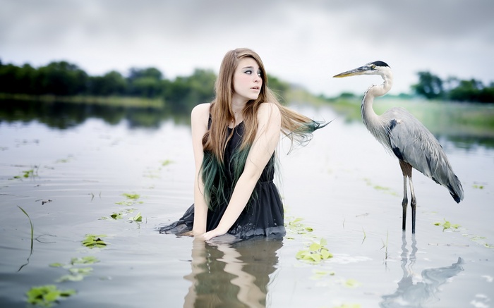 Woman and bird in water