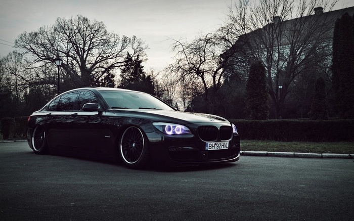 Black BMW 7 Series sedan parked on asphalt