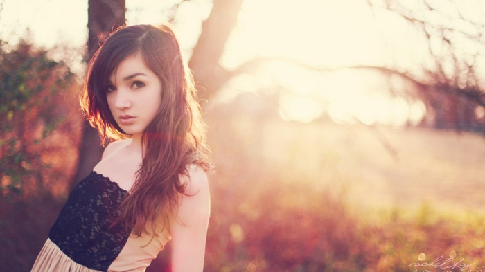 Brunette woman in a dress outdoors