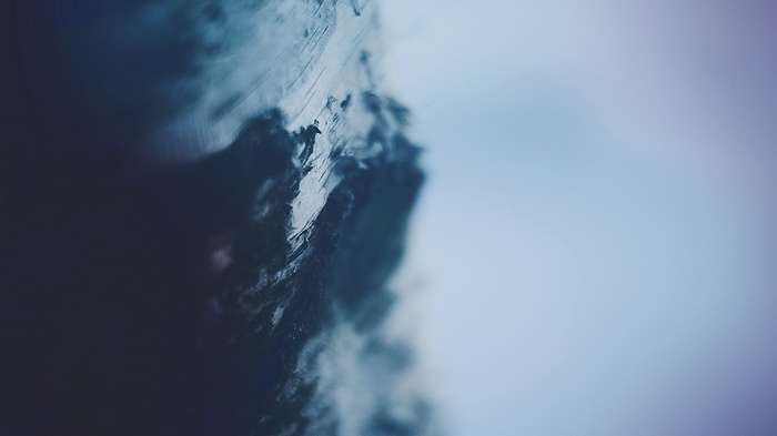 Close-up of a dark, textured surface with a blurred background
