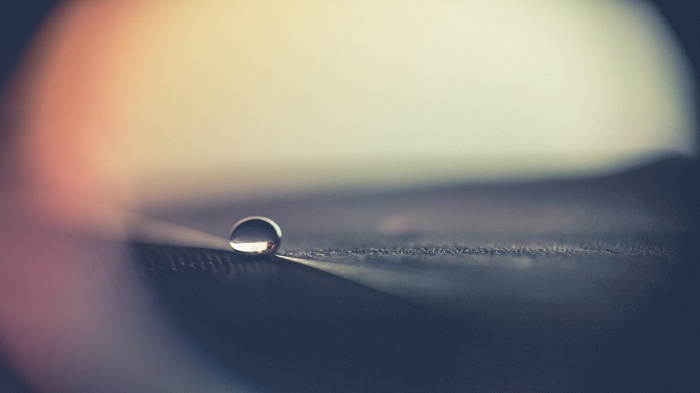 Macro shot of a single water drop on a surface
