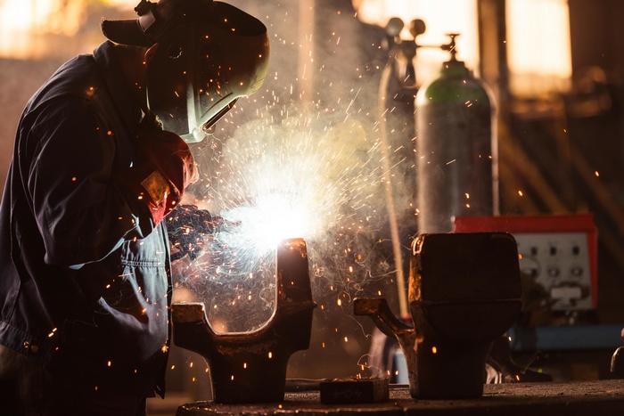 Man welding metal with sparks flying