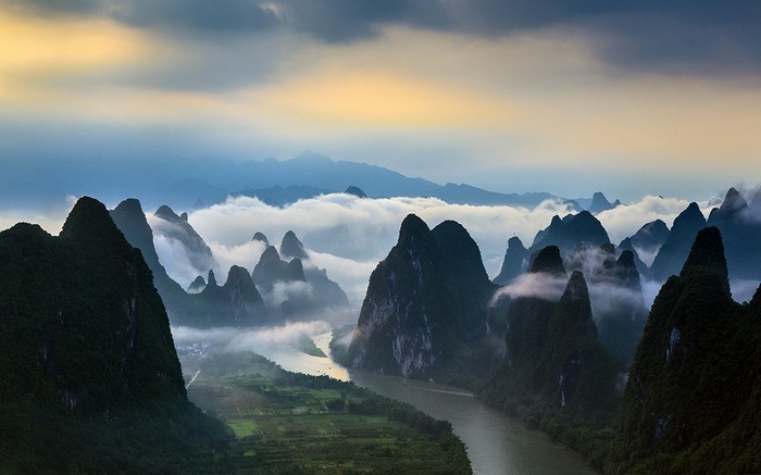 Karst mountains and river in China with clouds