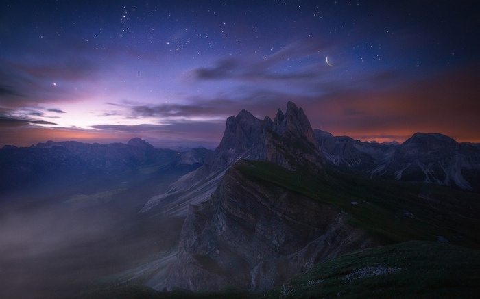 Starry night over the Dolomites mountains in Italy