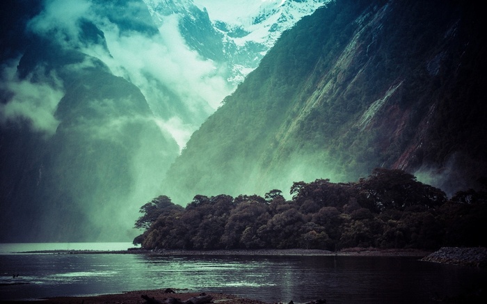 Misty mountains and forest by a lake