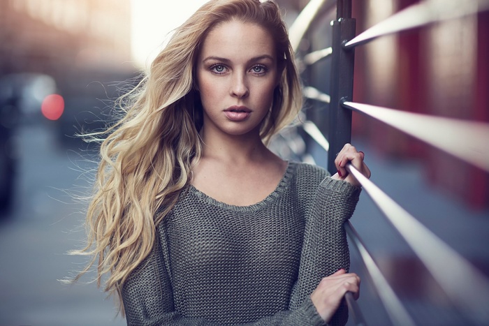 Woman with blonde hair wearing a sweater